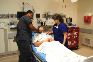 ER Tech Muaz Waqialla and ER Nurse Donna Jameson providing care to Jake Freudenberger at the Jackson Street Emergency Room.