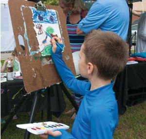 Blake Mecham painting at the Art Walk.
